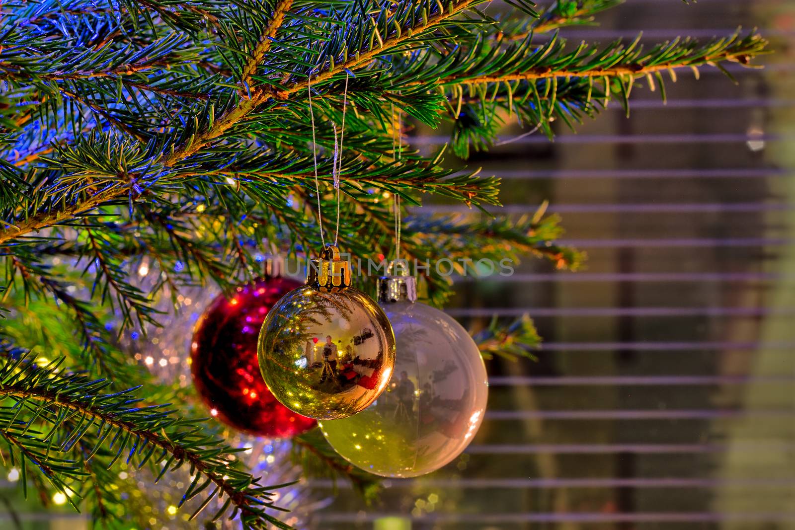 Sparkling ornaments on a christmas tree on Christmas eve.
