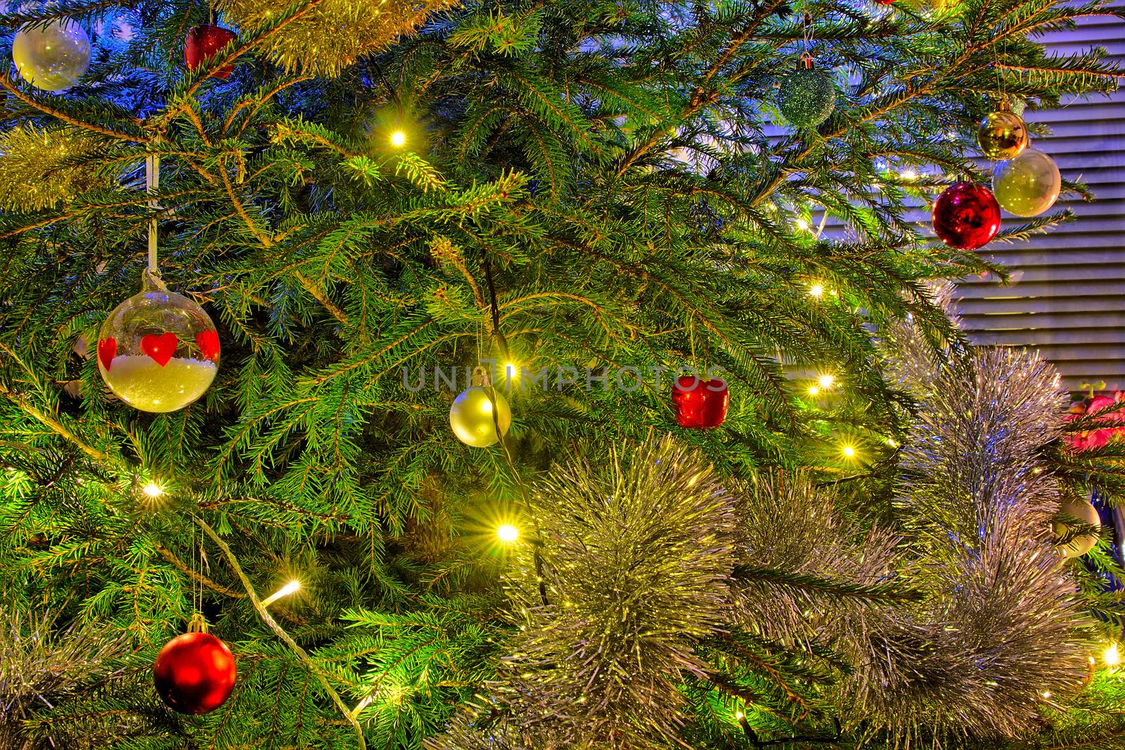 Red, green and golden colors of Christmas. Shiny decorations on a christmas tree.