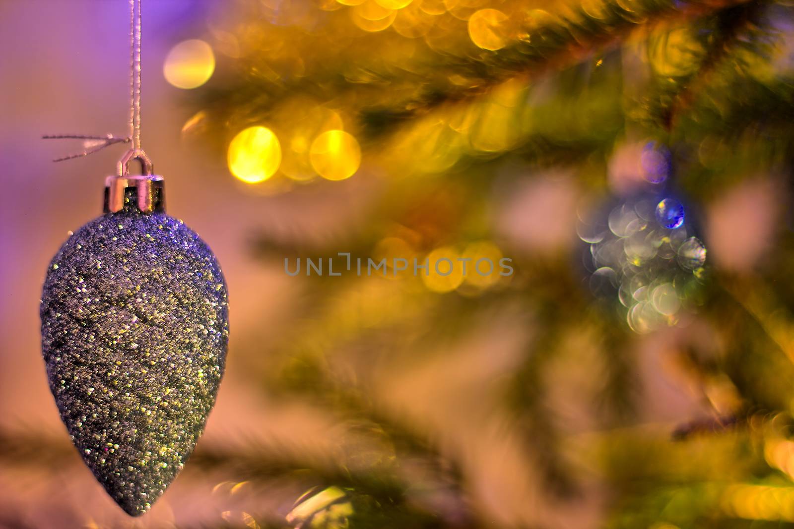 Cone shaped christmas tree decoration on a blurred background.