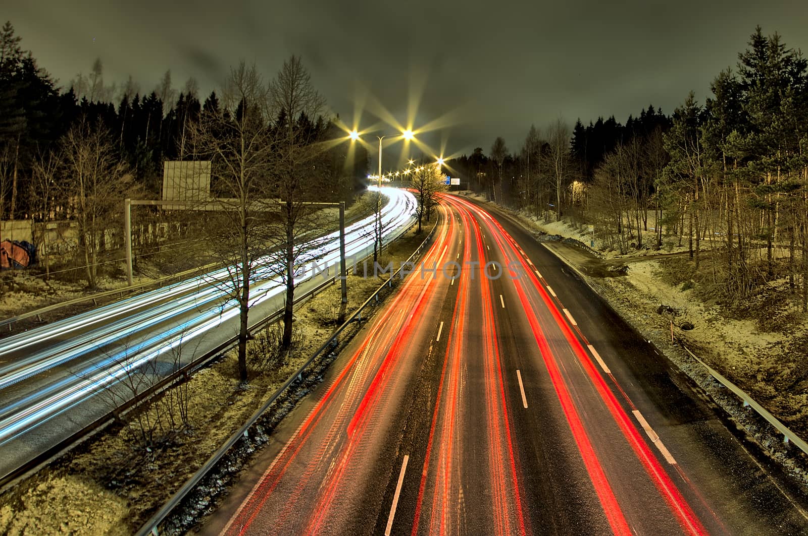 Late night rush hour. People driving home from work in the city. Light trails, long exposure.