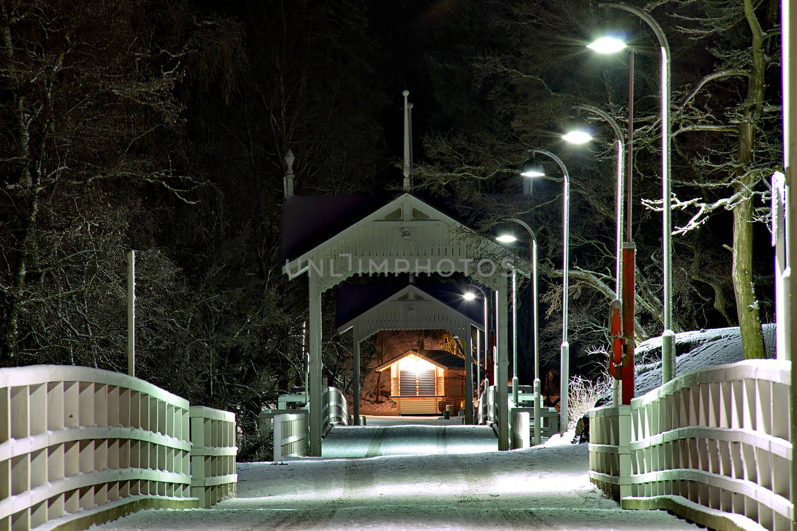 Bridge to Seurasaari in Helsinki. Lighted path photo captured in the dark at night.