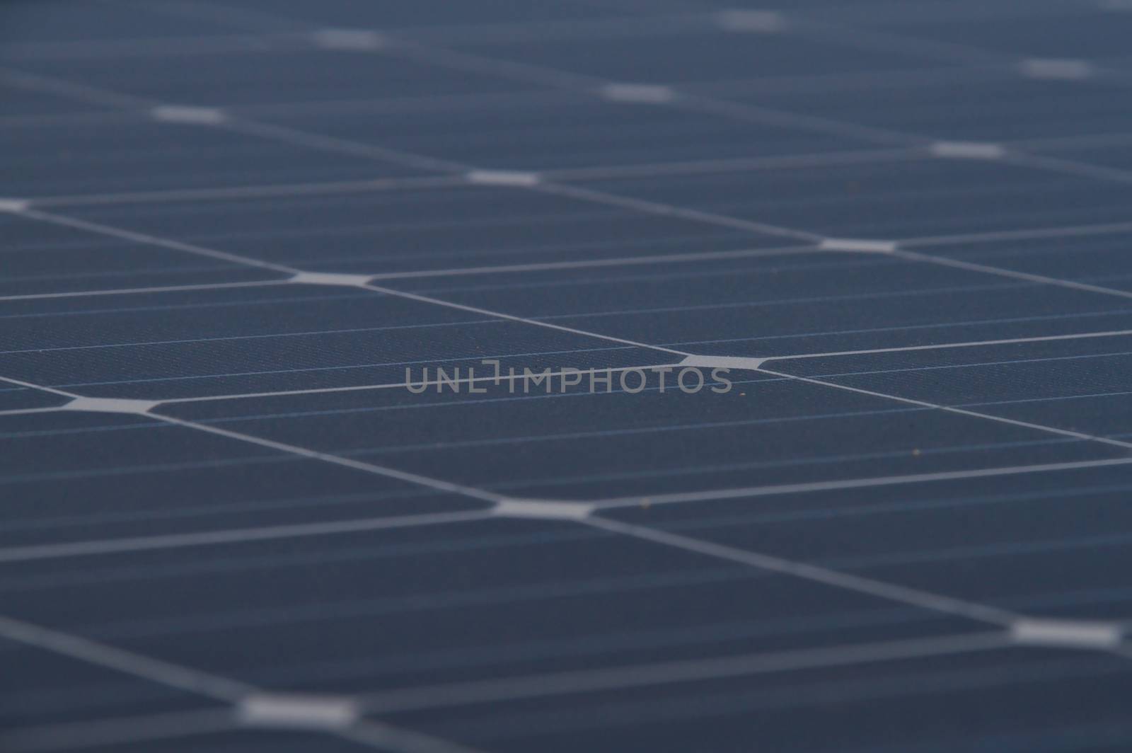 Low angle photo of the surface of a solar panel that produces electricity directly from the sunlight.