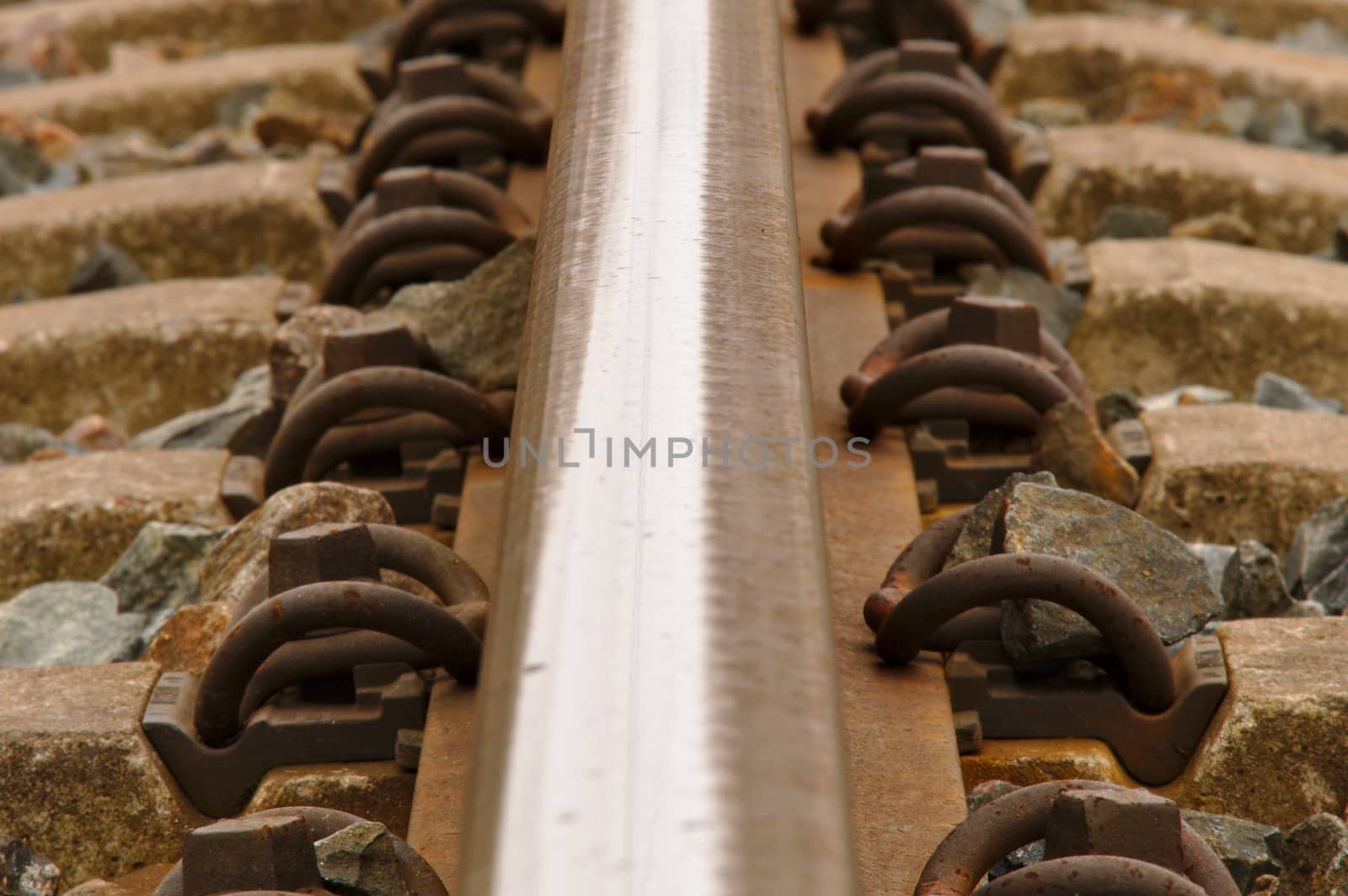 Closeup of a single rail of a railway.