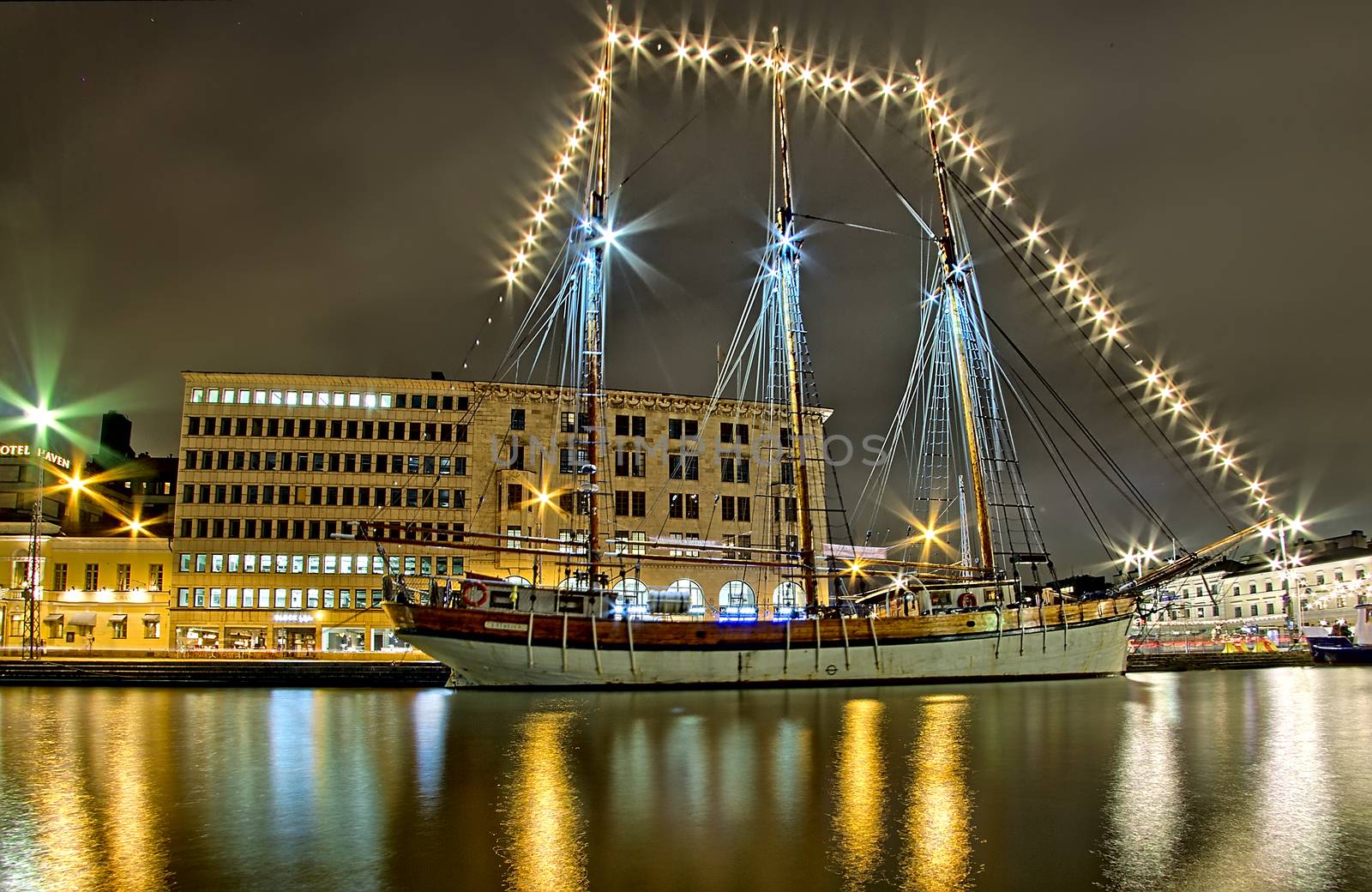 Night photo of a lighted old sailboat at the Kauppatori Helsinki. Photo taken in winter 2018 in Helsinki, Finland