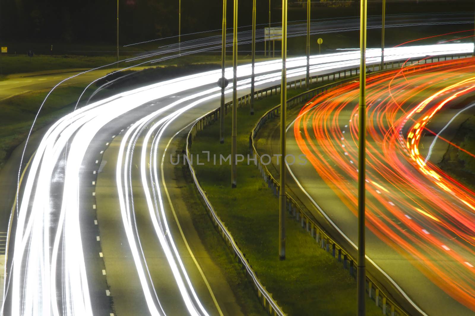 Curved light trails on a highway.