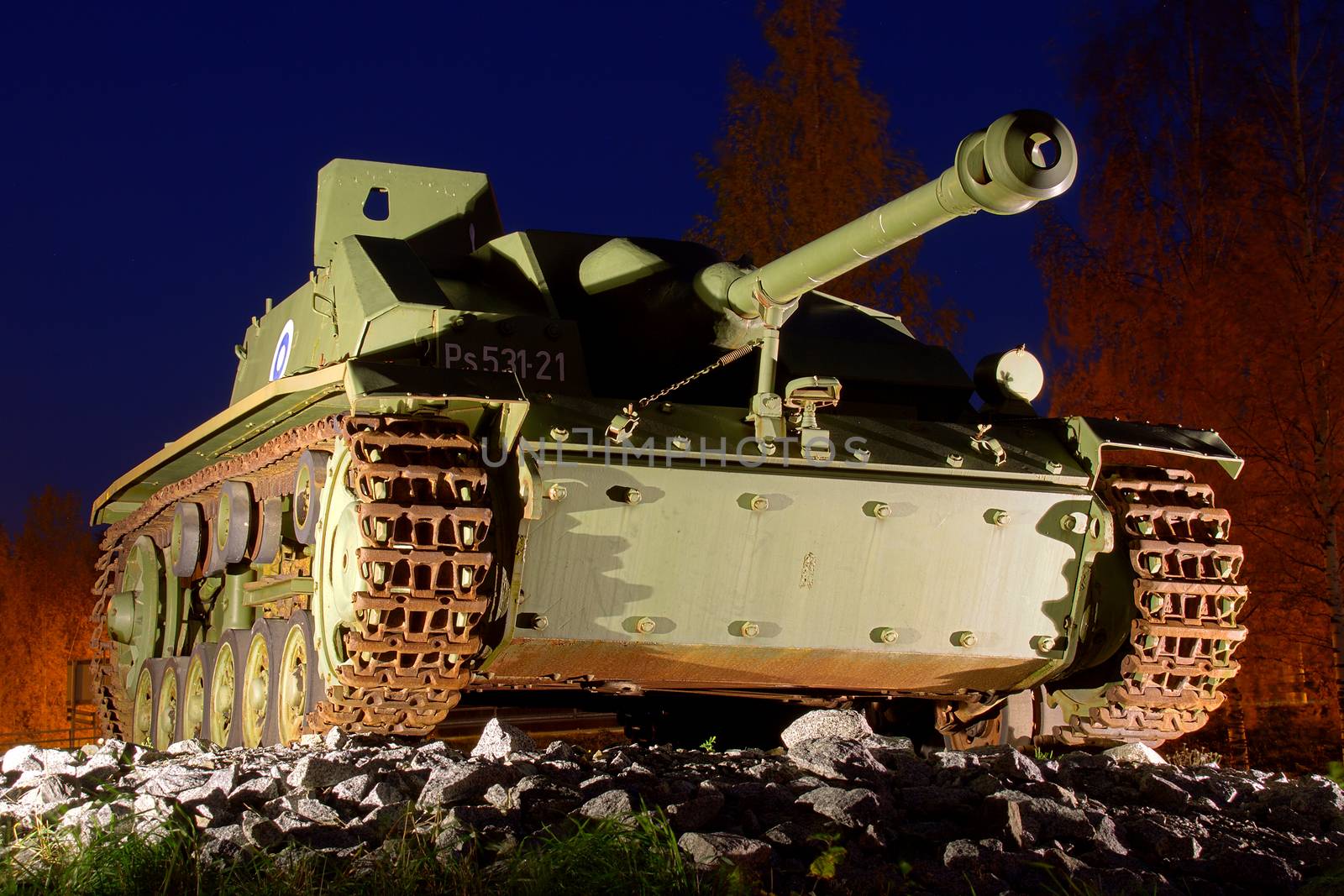 Lighted old tank at the top of the hill at night