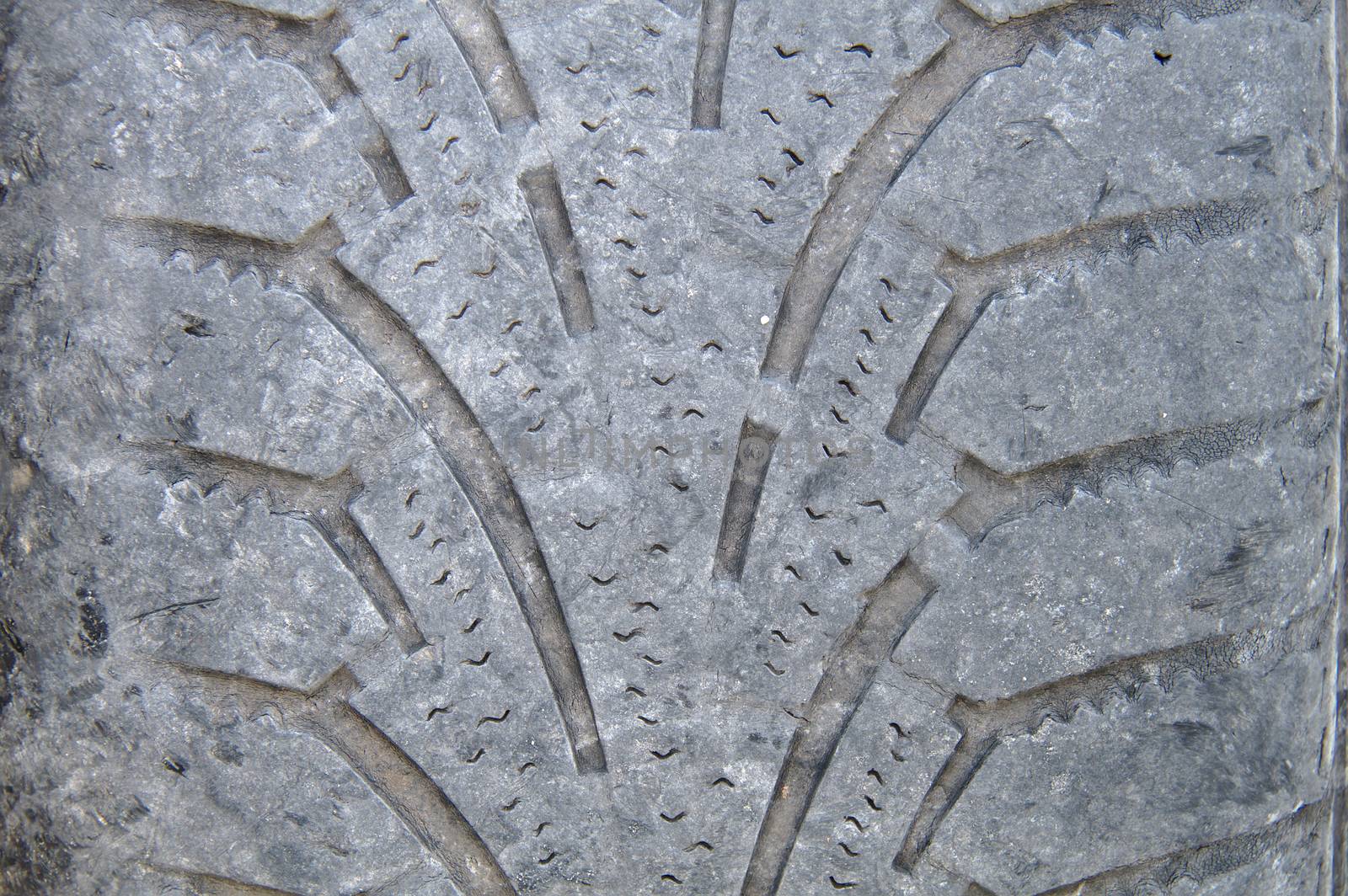 Closeup of a worn out tire of a car. Tires have to be changed before winter in northern countries.