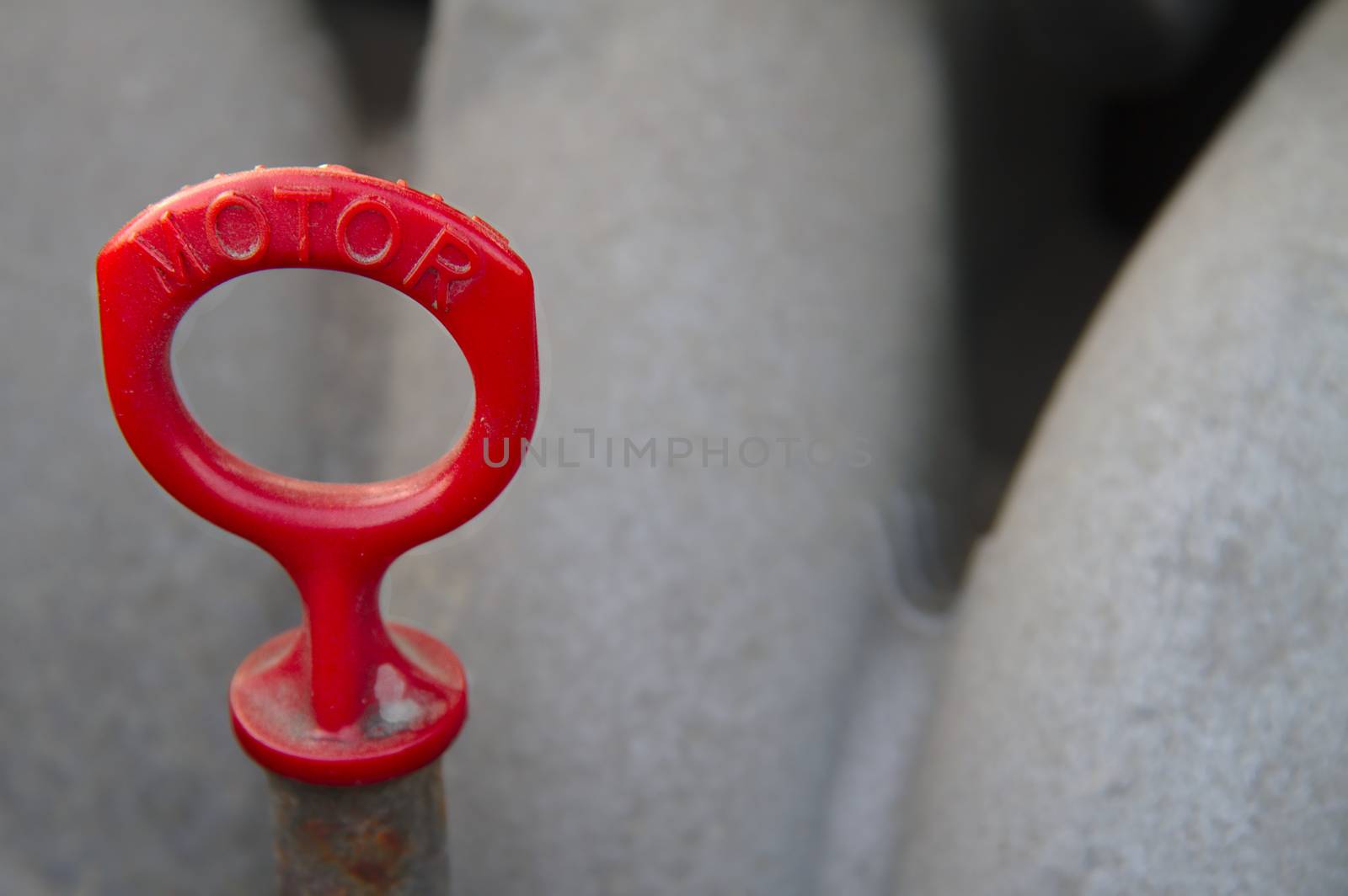 Red ring on top of the oil stick. Check oil level of the engine of your car.