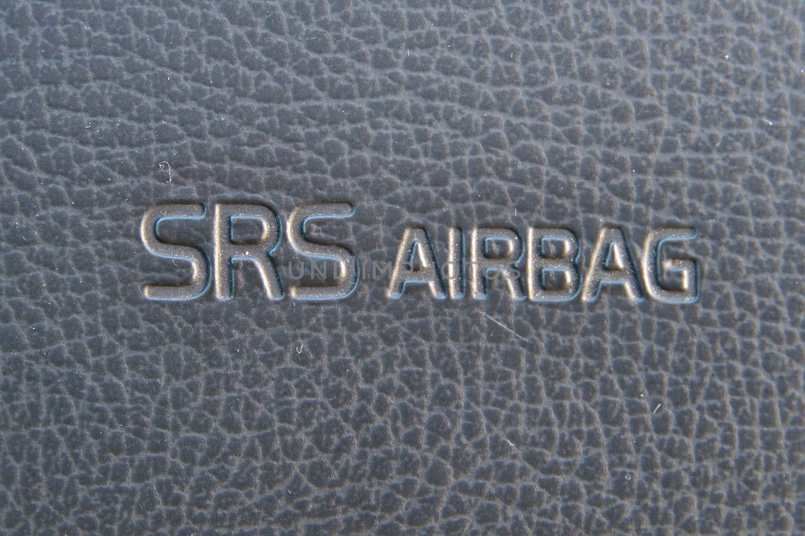 SRS Airbag warning text on passanger side dasboard of a car. by Valokuva24