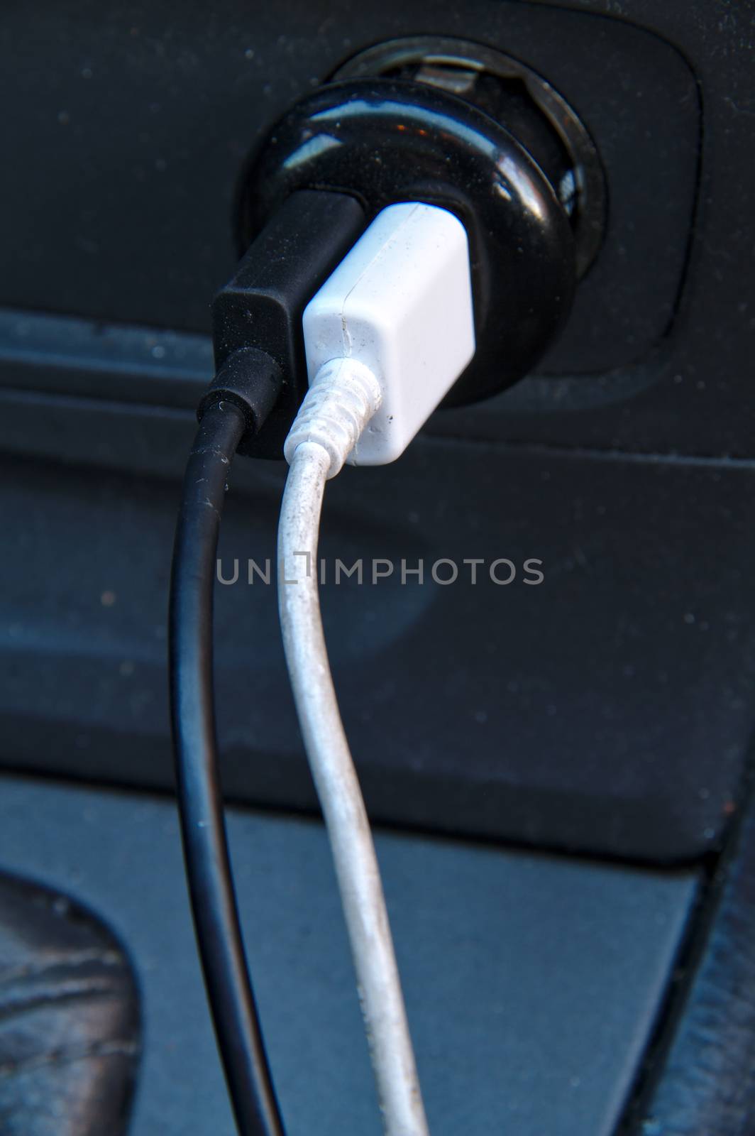 Two charging cables coming from 12v USB charger of a car. by Valokuva24