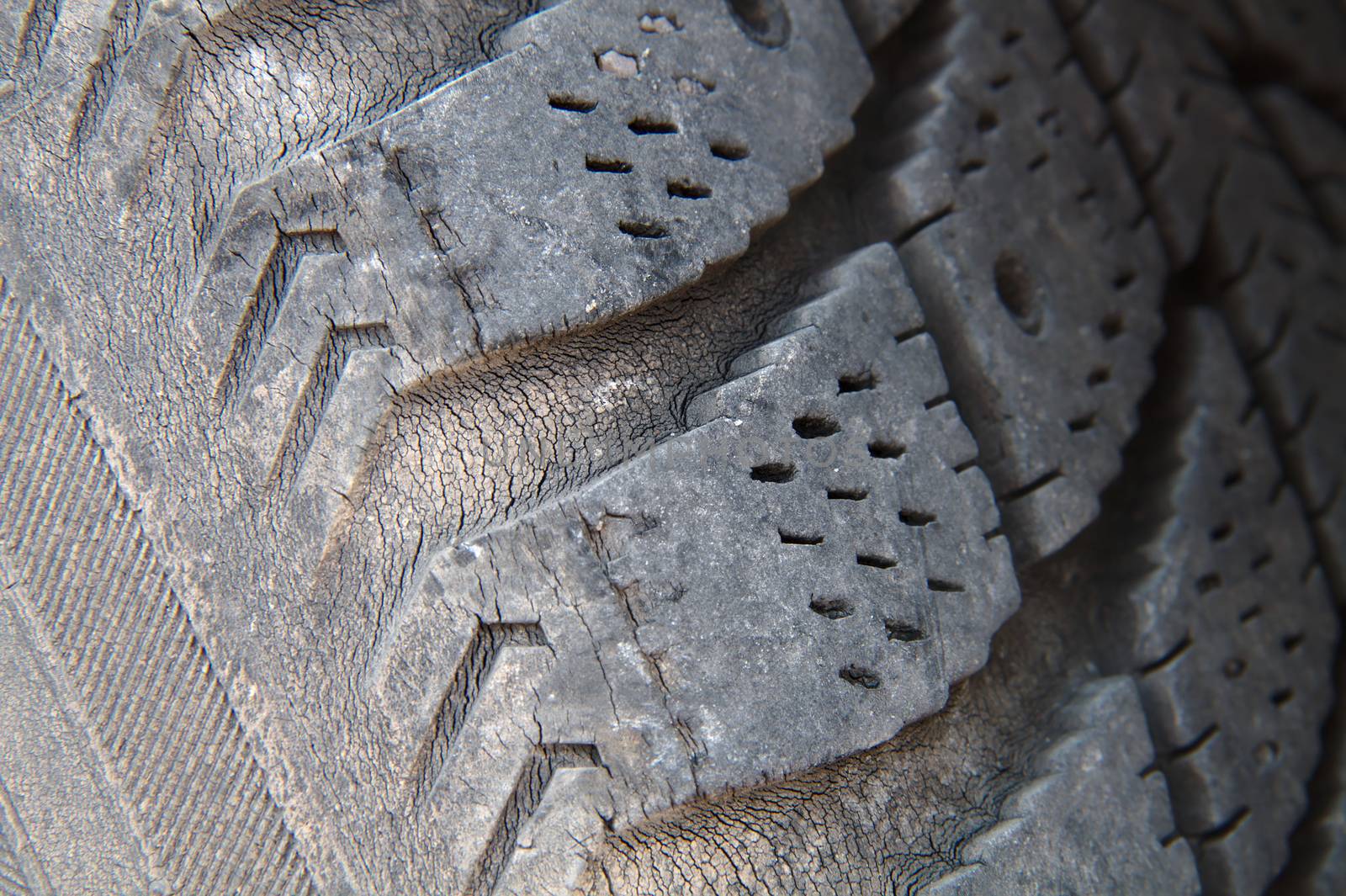 An old tire of a car full of micro cracks.