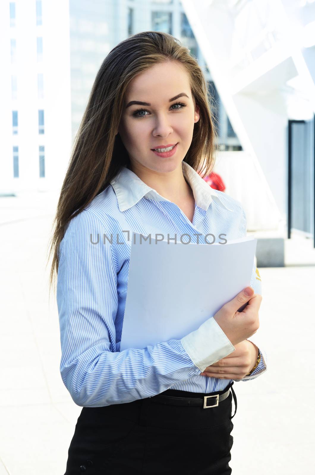 Portrait of a beautiful young girl student of European appearance who holds sheets of paper, clouse-up