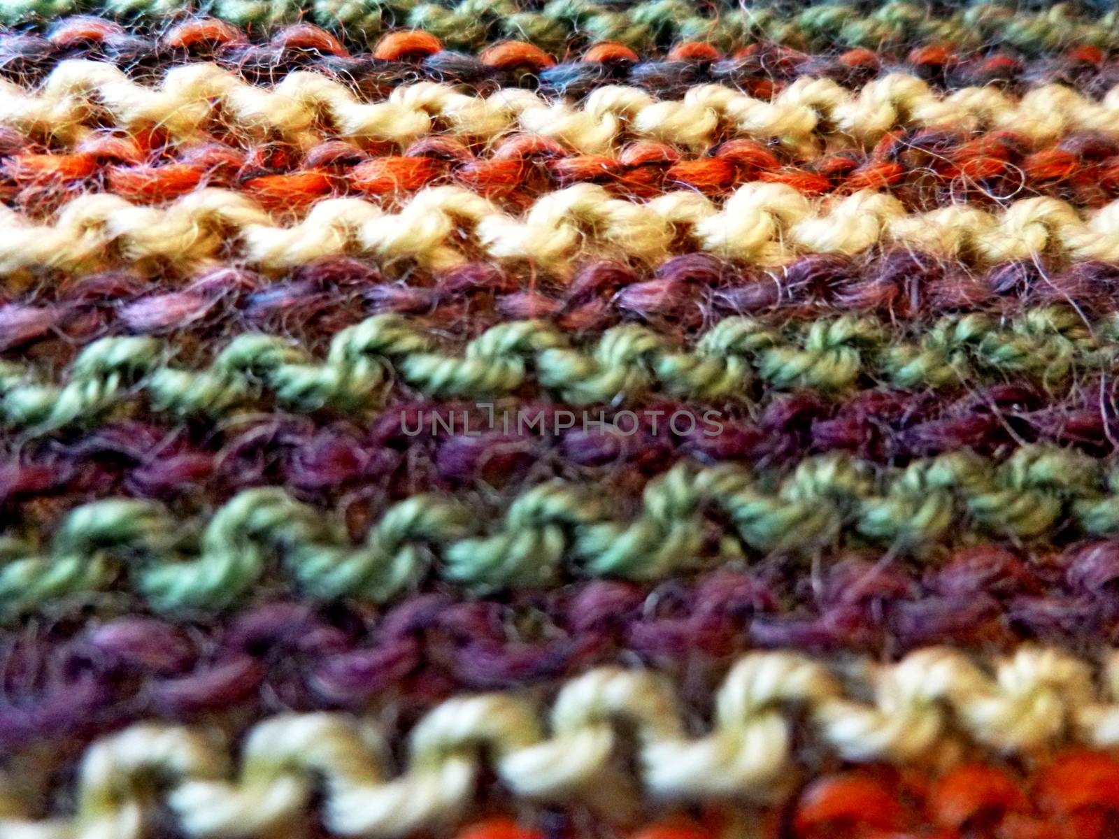 Knitted multicolored fabric texture. Background image Close-up. Hobbies, leisure, crafts