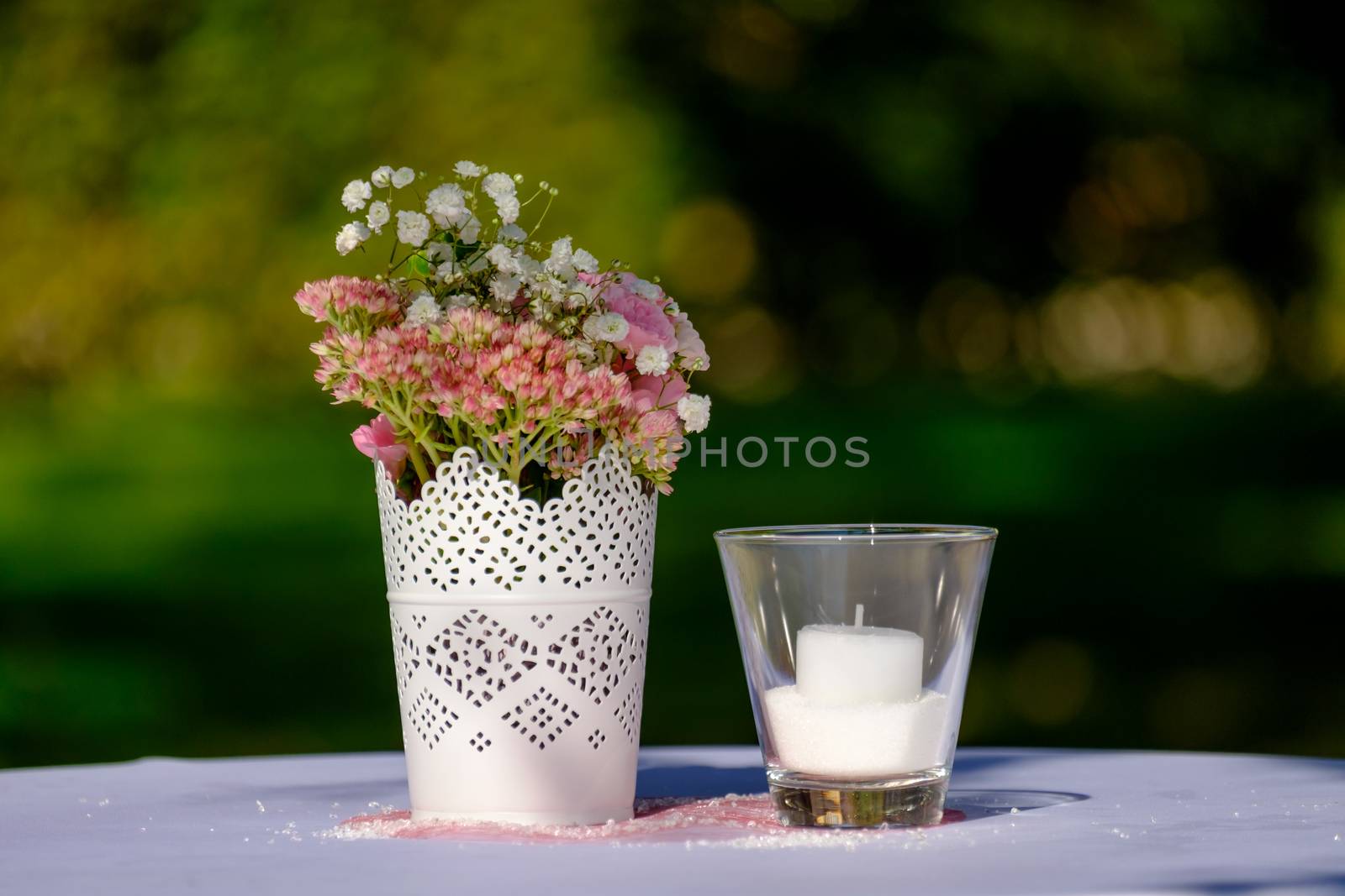 Wedding decoration with flowers and candle on a table