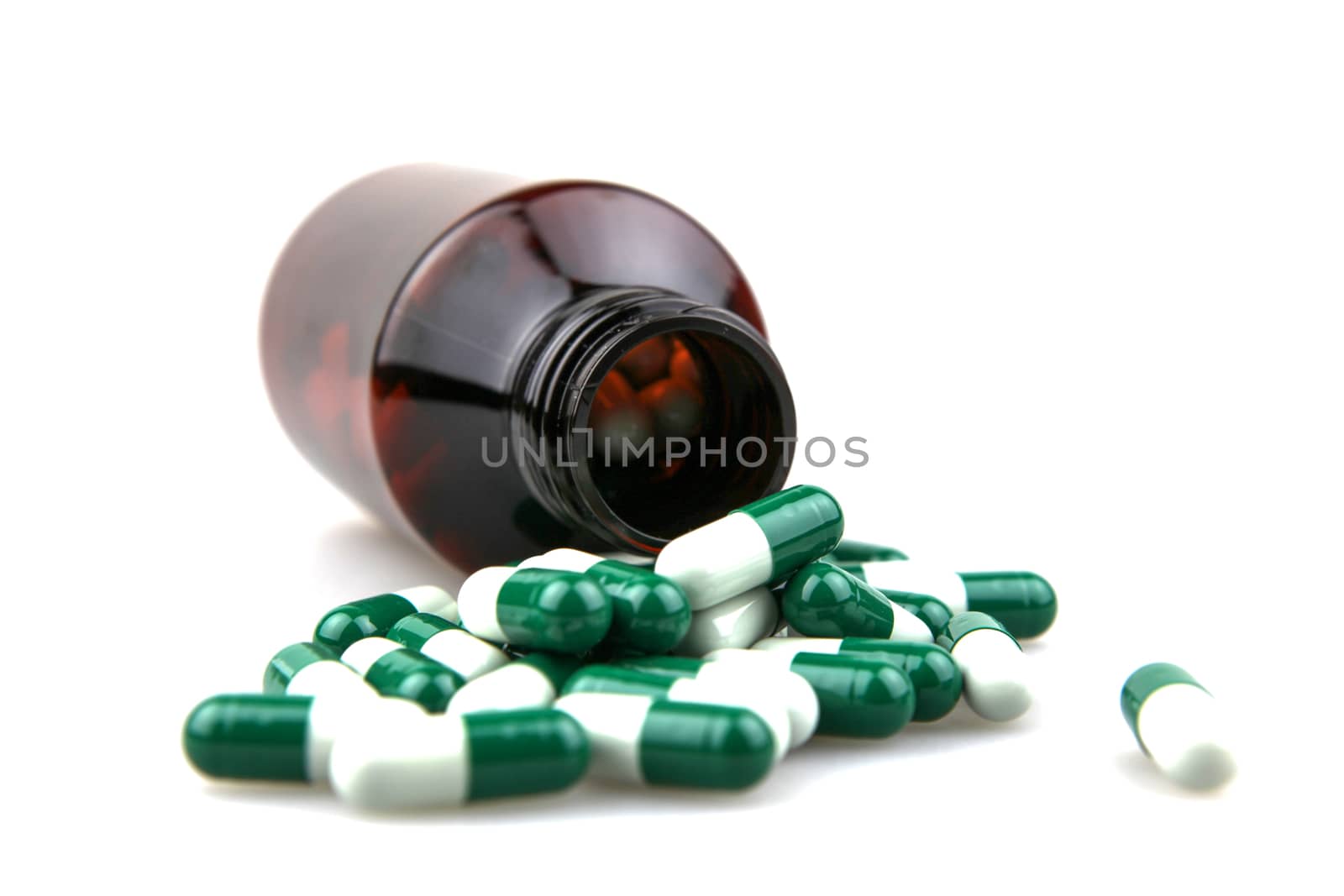 Pill bottle with medications over white background