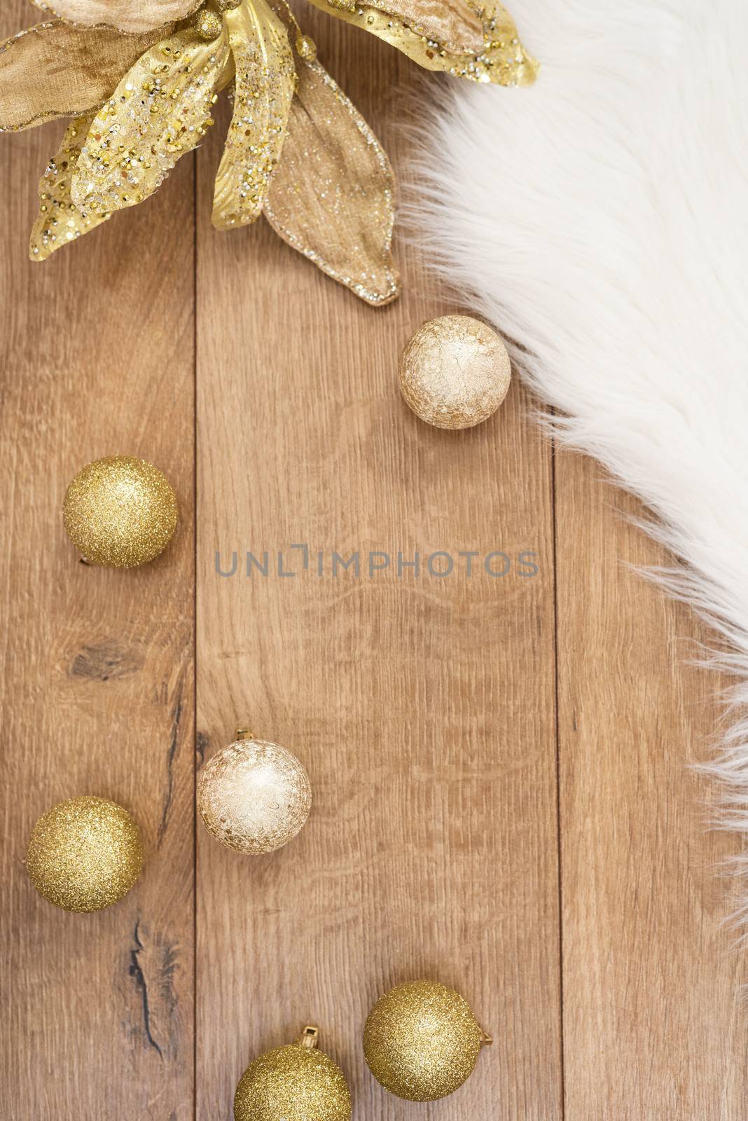 Christmas background. Gold Christmas balls on a wooden background. Winter holidays concept. Top view with copy space, vertical image.