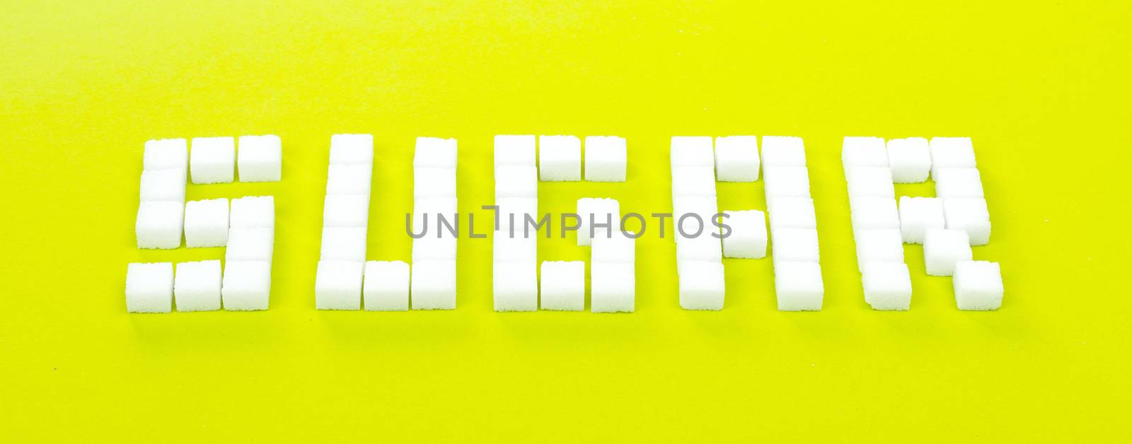 White sugar cubes background - Concept of unhealthy eating