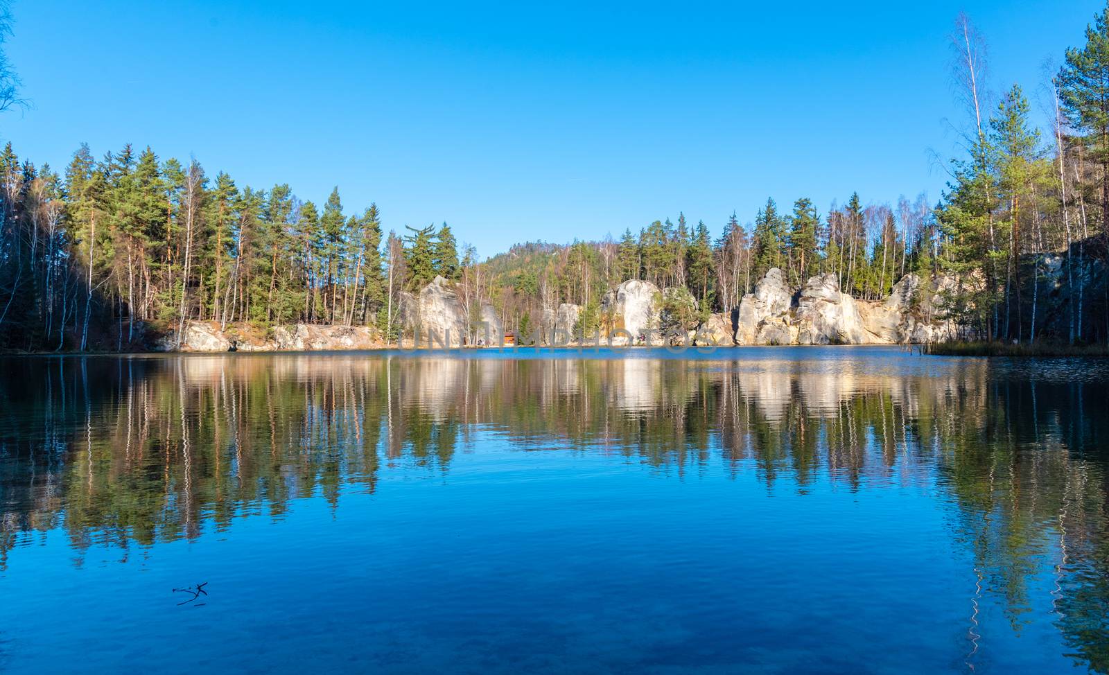 Natural lake in Adrspach rocks on sunny autumn day. Adrspach-Teplice sandstone rock town, Czech Republic.