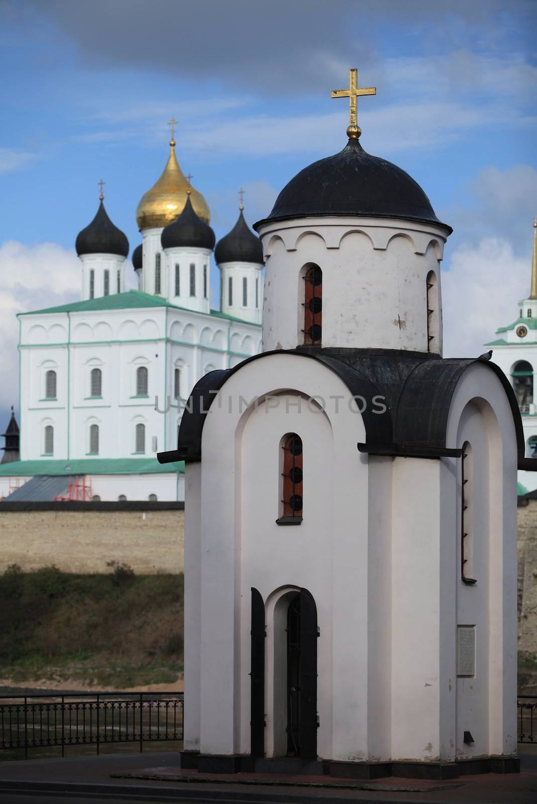 chapel with a golden cross in the distance Pskov kremlin