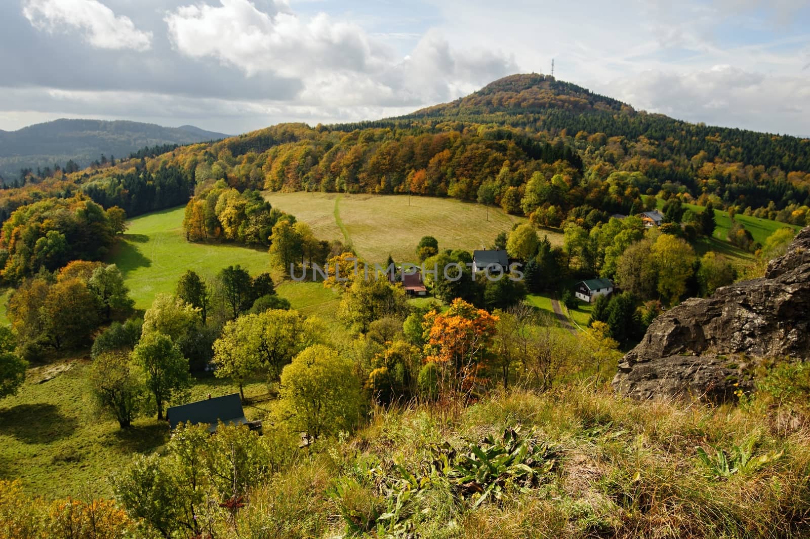 Autumn colorful landscape with forests, hills, sun and sky