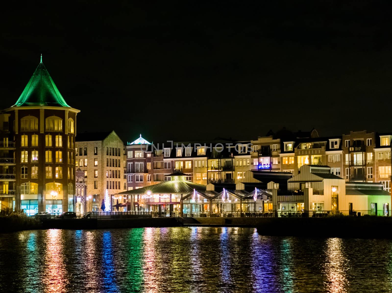 beautiful view from the water on center vleuterweide in the Meern ,Utrecht, The Netherlands. colorful cityscape with many buildings and lights