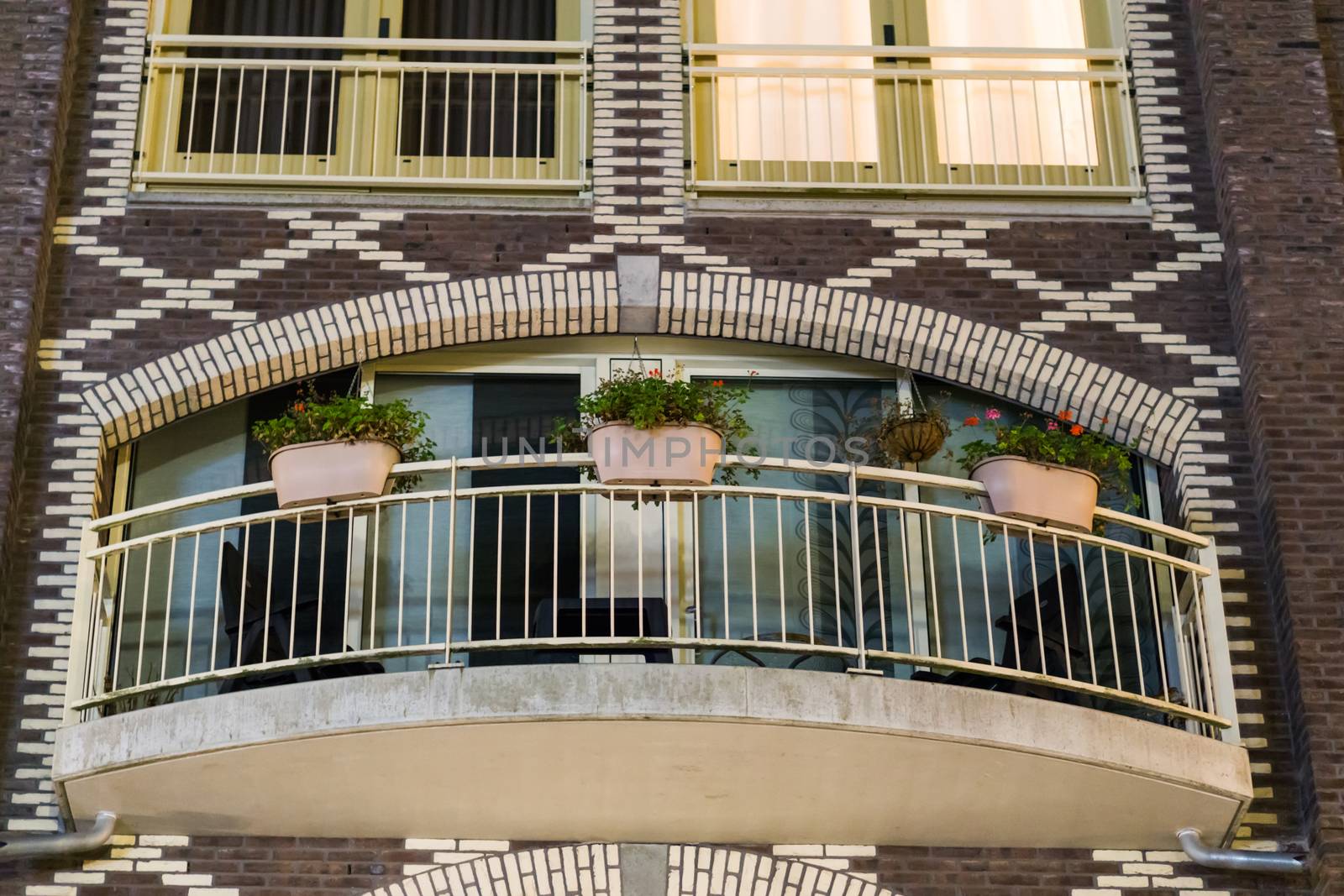 modern city balcony decorated with flower baskets