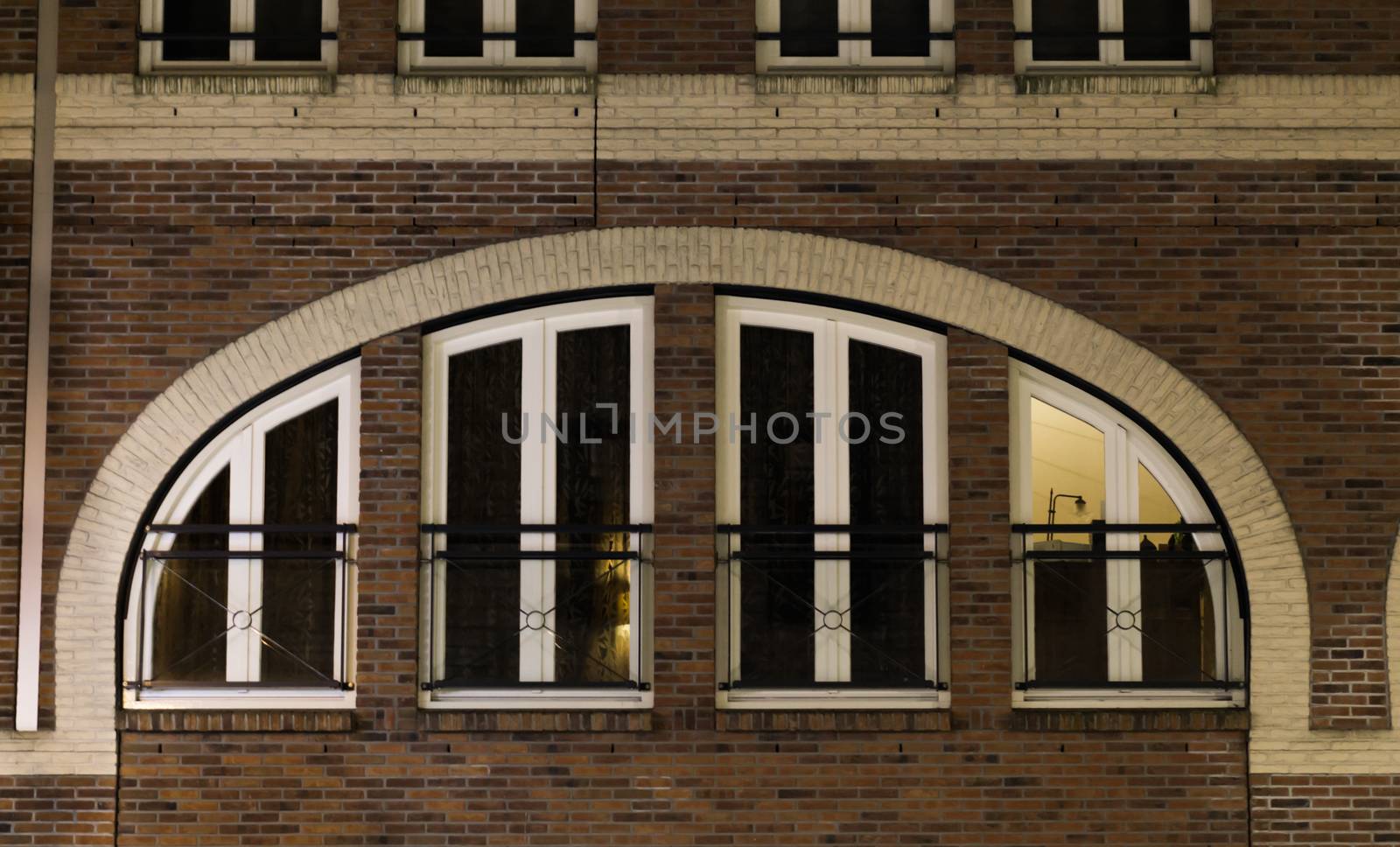 beautiful city windows next to each other under a arch, modern dutch architecture background