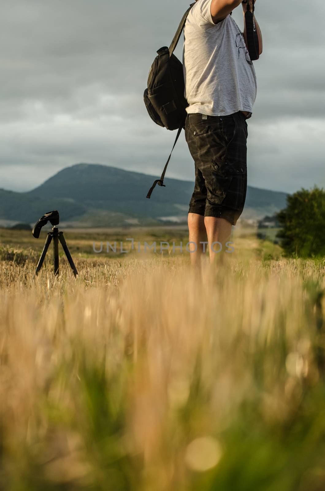 Amateur photographer in actions with his tripod at the side. Pam by mikelju