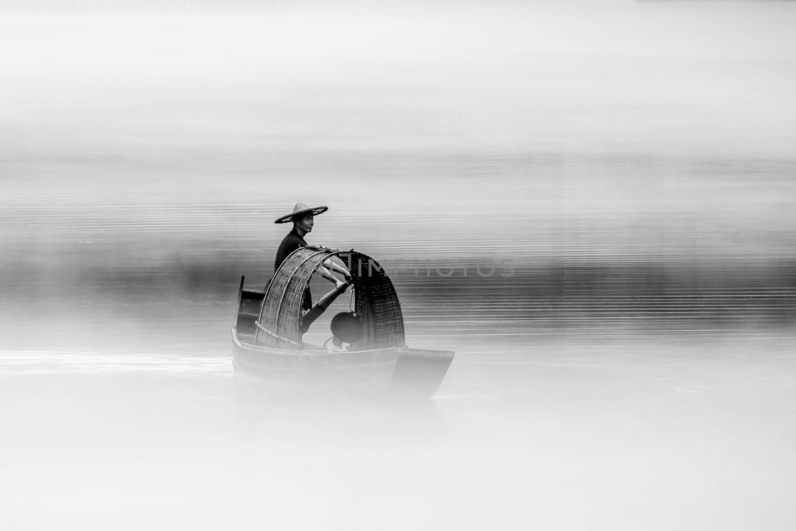 A fisherman in the famous Misty Small Dongjiang (east river) in Chenzhou, Hunan province of China.