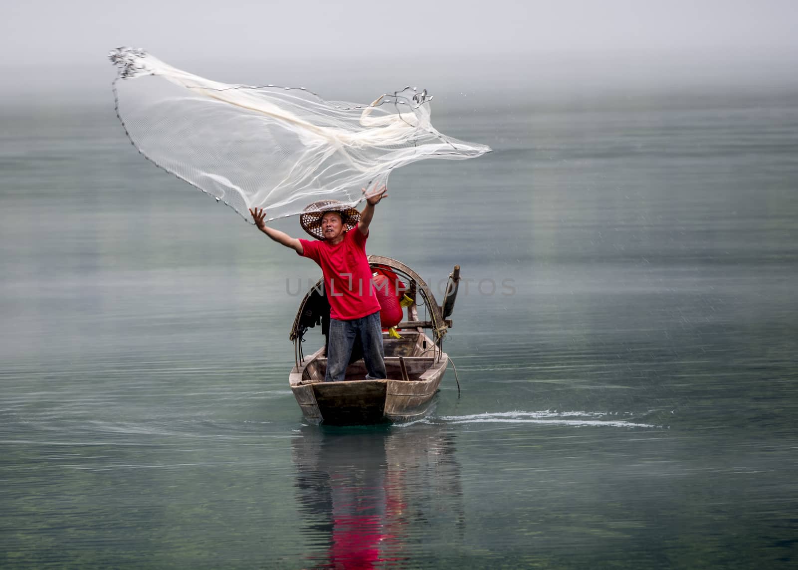 A fisherman in the famous Misty Small Dongjiang (east river) in Chenzhou, Hunan province of China.