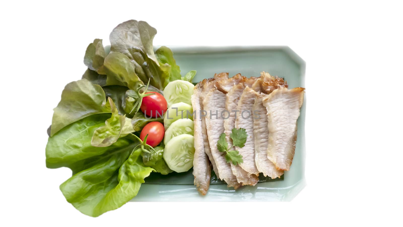 slice of grilled pork served with fresh vegetable