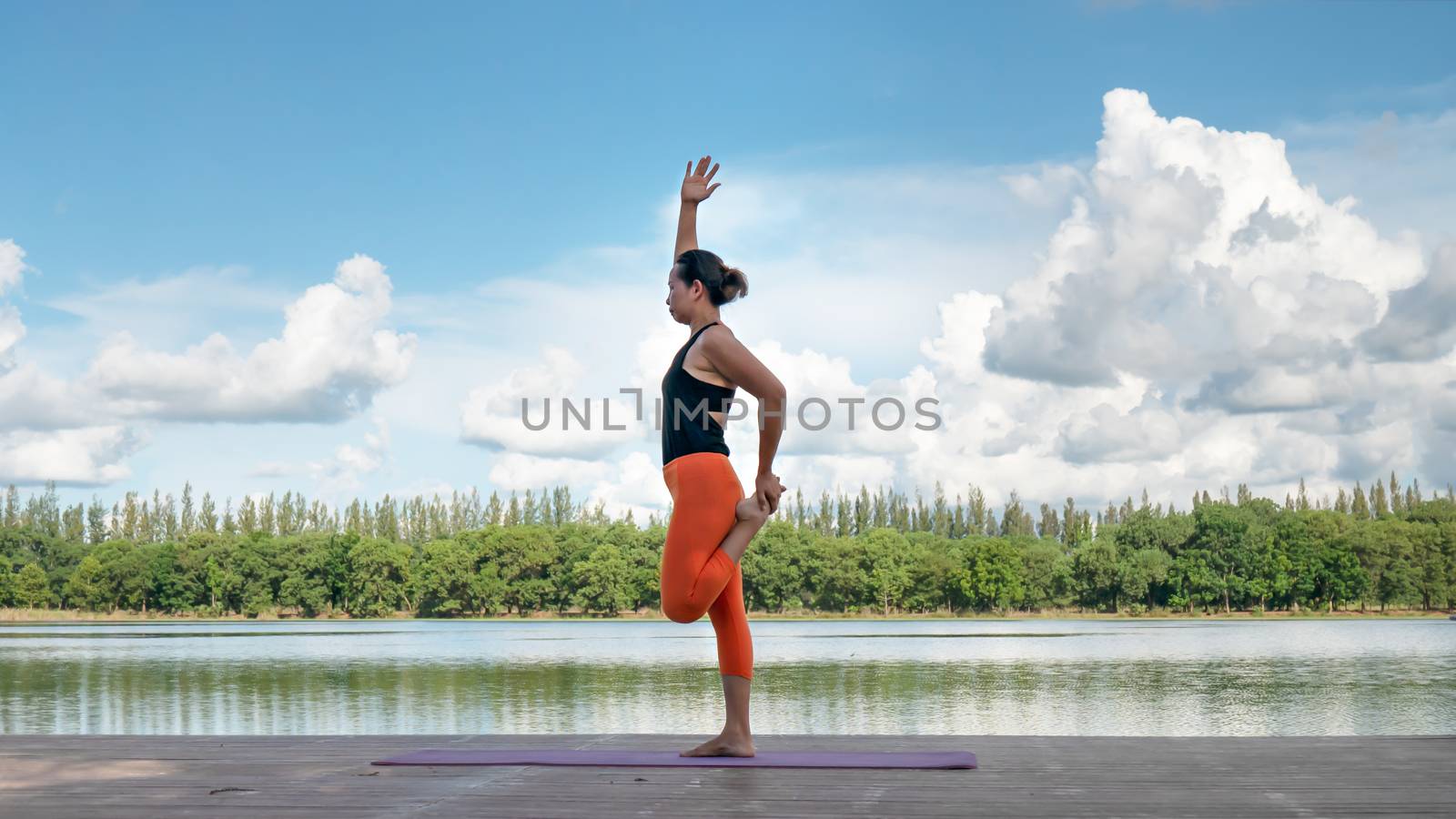 Asian woman practicing yoga pose by rakratchada