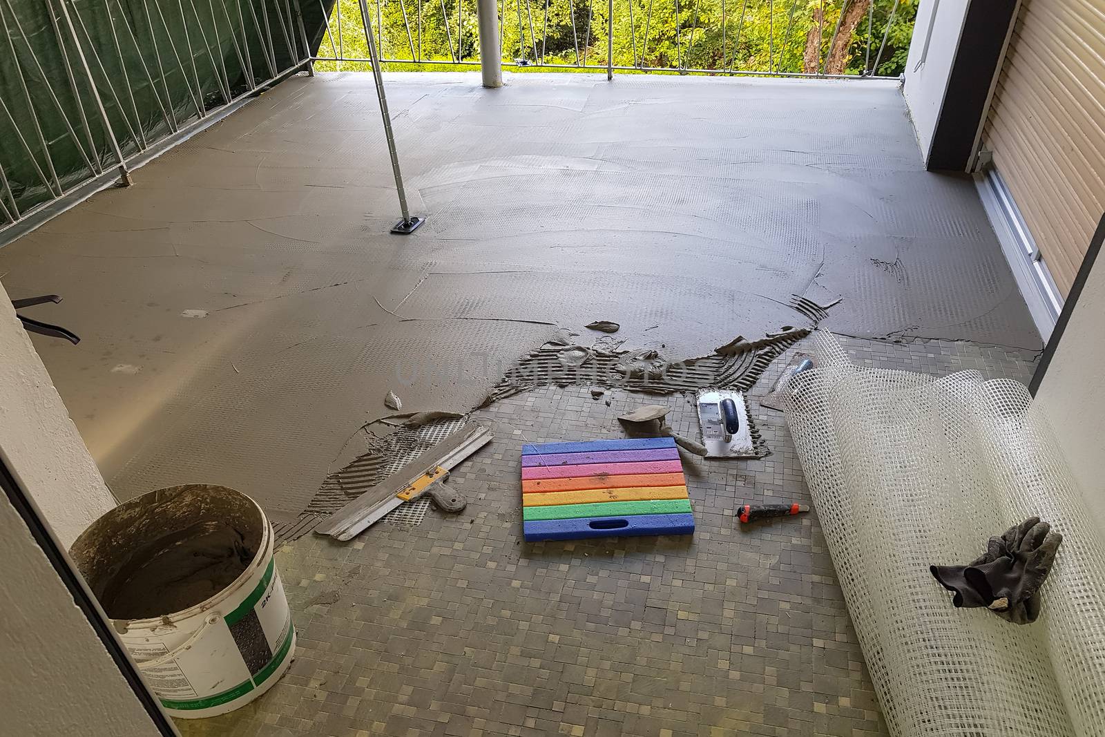 Balcony floor tiles installation. Laying tiles from porcelain. Interior remodeling theme.