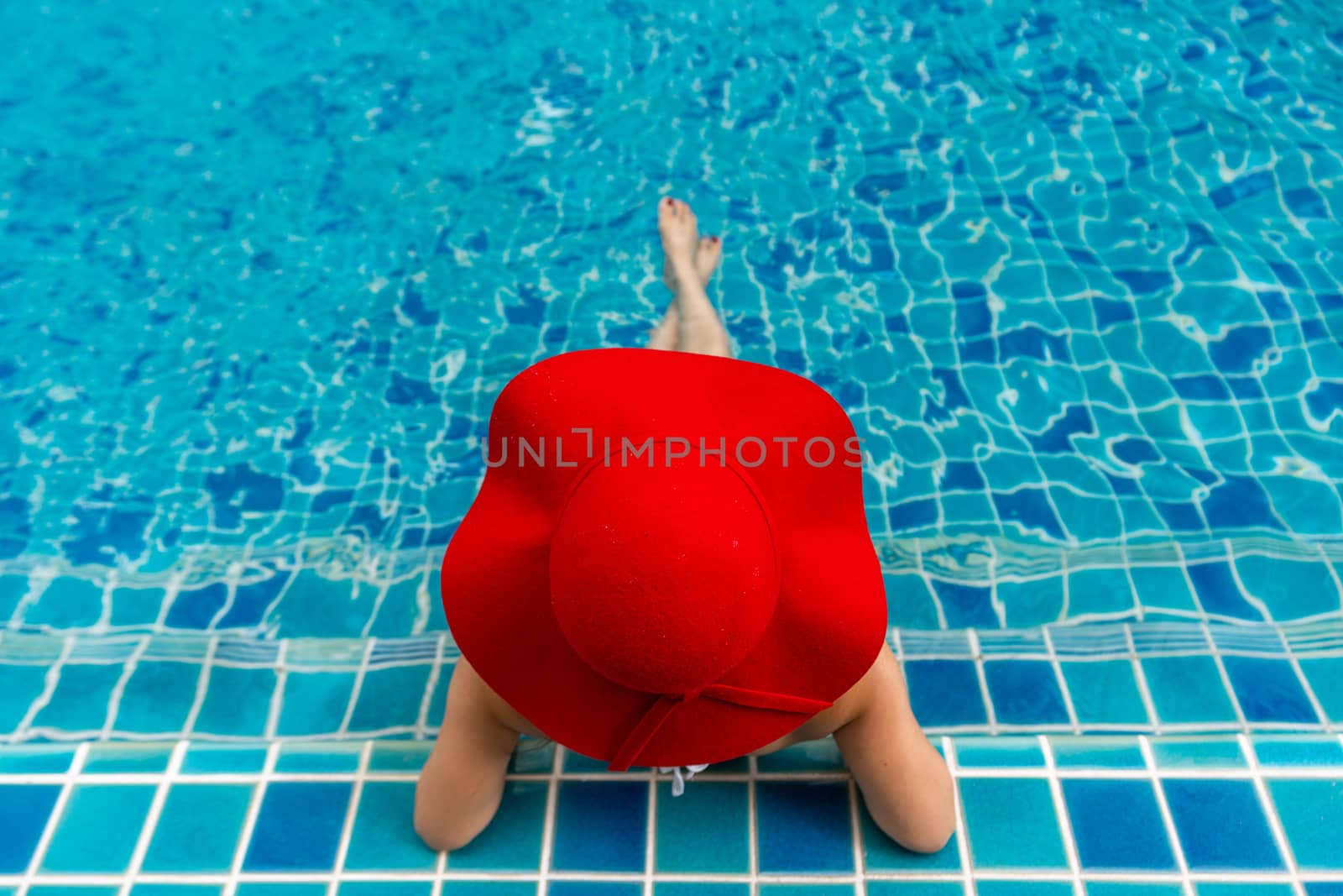 Asian woman relaxing in swimming pool.