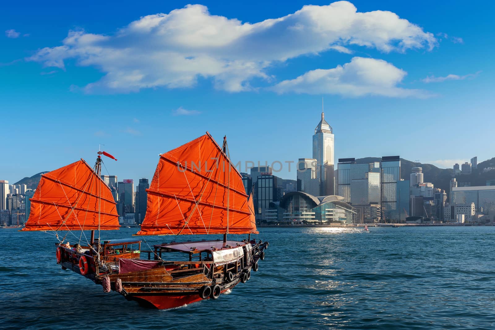 Victoria Harbour with junk ship in Hong Kong. by gutarphotoghaphy