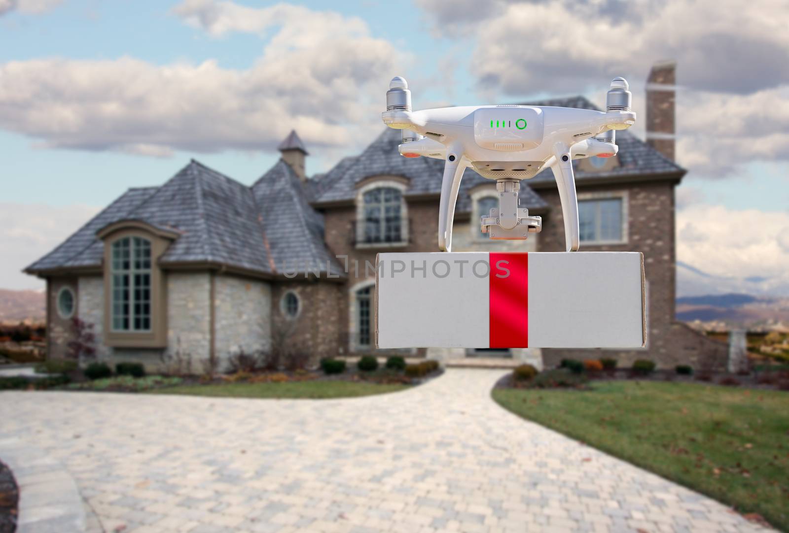 Unmanned Aircraft System (UAV) Quadcopter Drone Delivering Box With Red Ribbon To Home by Feverpitched