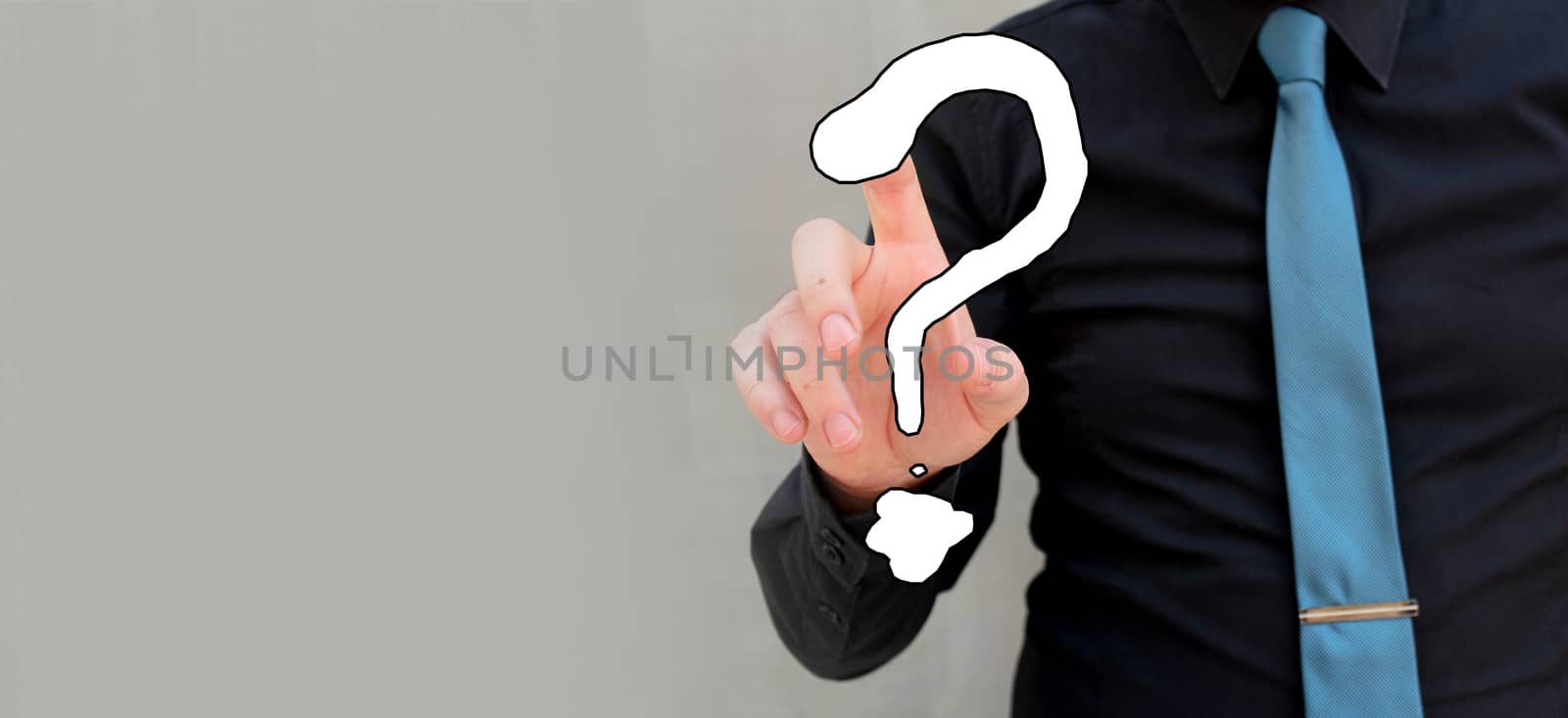 Man touching question mark with tip of his finger. Innovation and inspiration by negmardesign