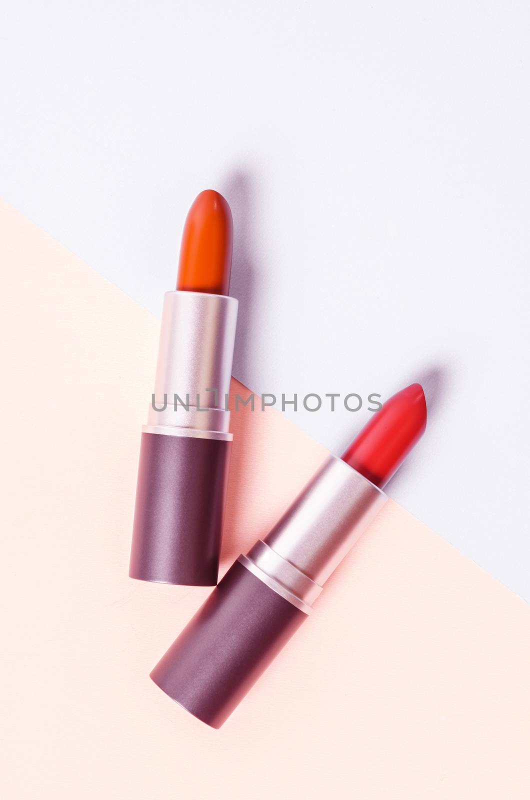 Lipstick. Fashion Colorful Lipsticks over beautiful background with color filter.