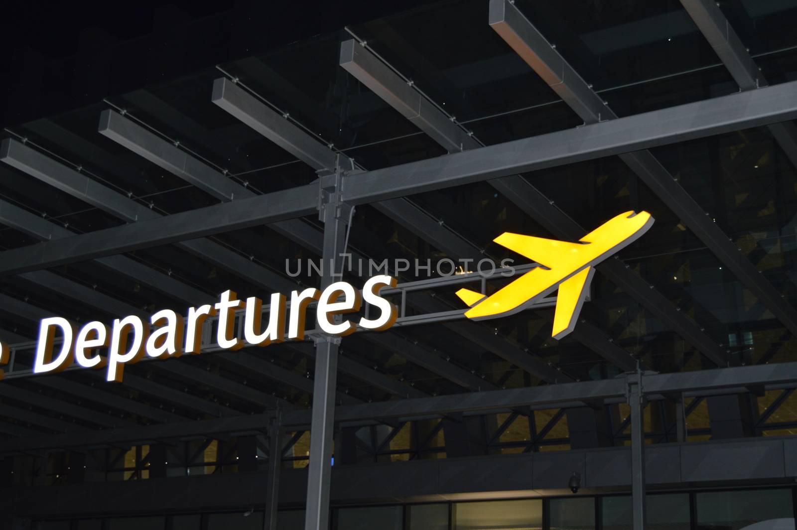 Information about the departure zone, signpost of the aircraft at the airport at night, the concept of travel.