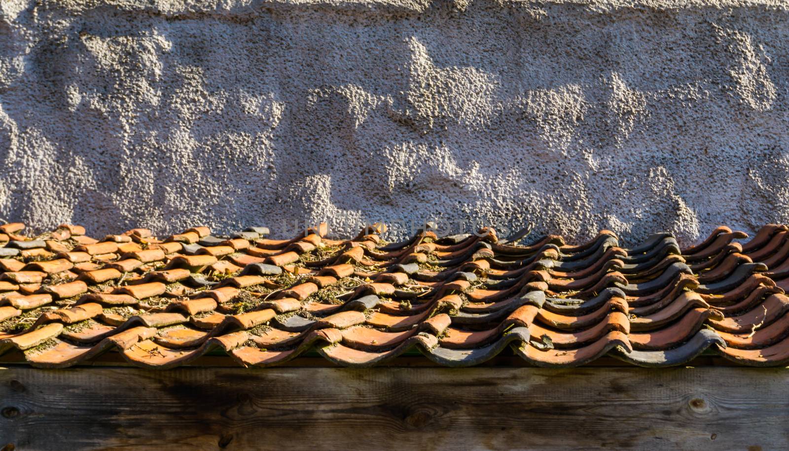 roof top with old and dirty tiling in the colors orange and black