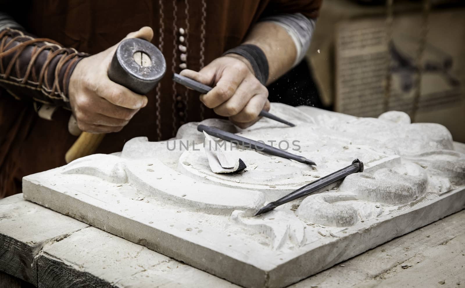 Carving stone in a traditional way, craftsmanship detail, shaping the stone