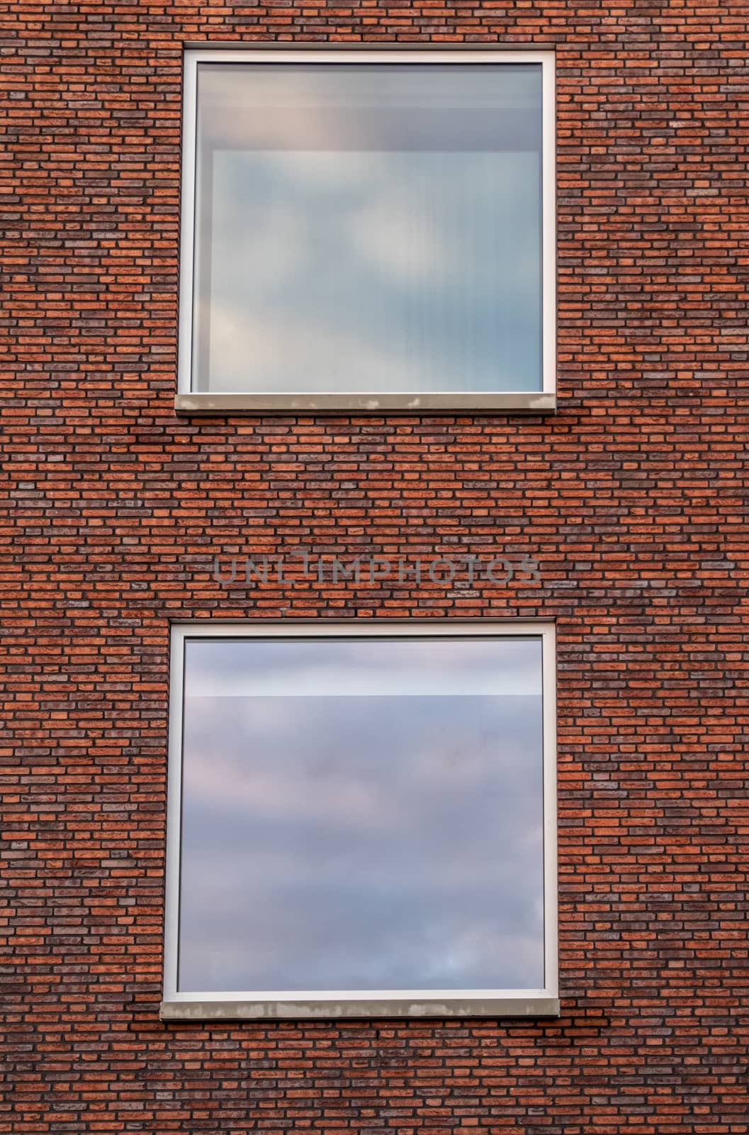 Two big windows with a Brick wall as architecture background.