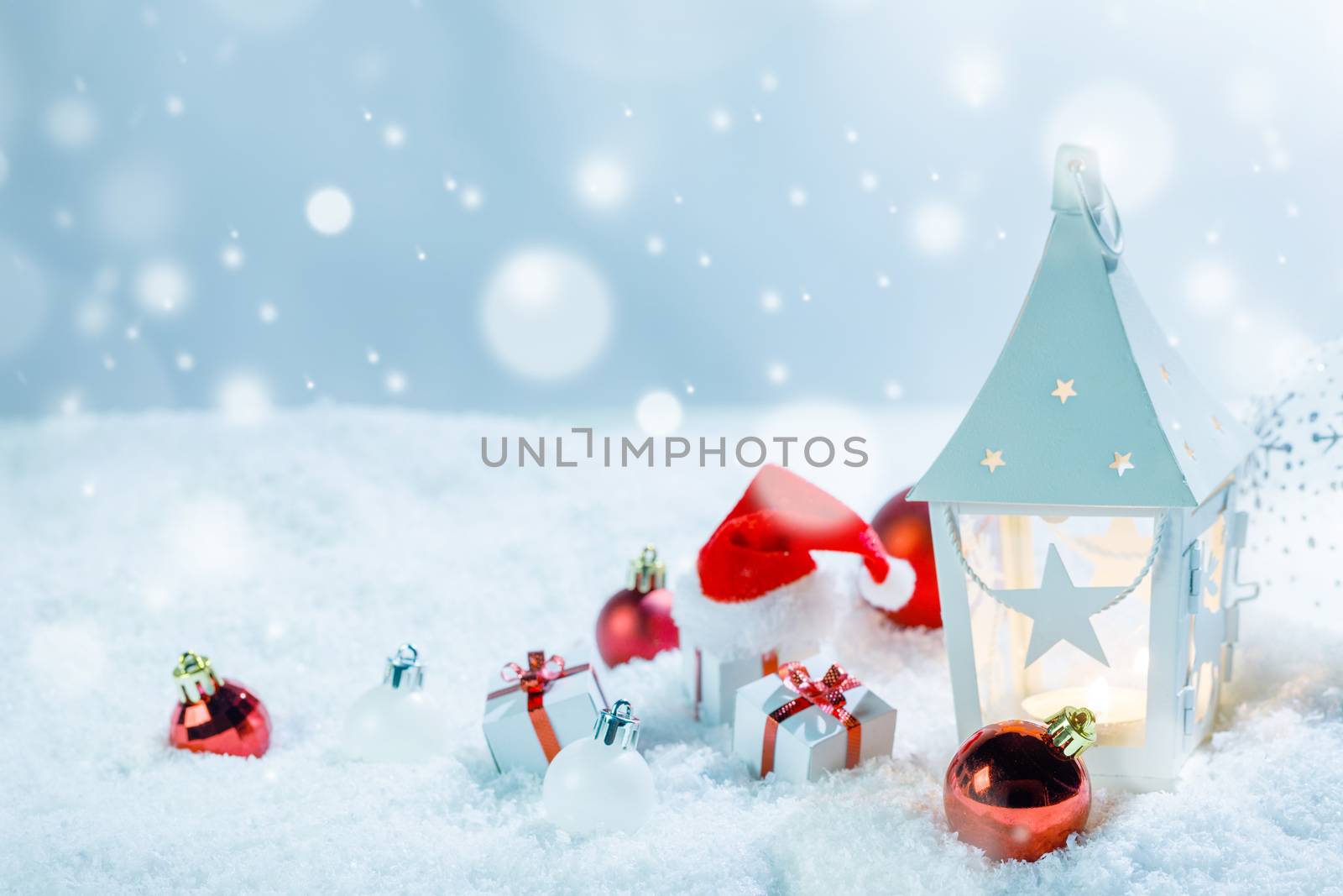Christmas holidays card with gifts , balls , sants claus hat and glowing lantern in snow