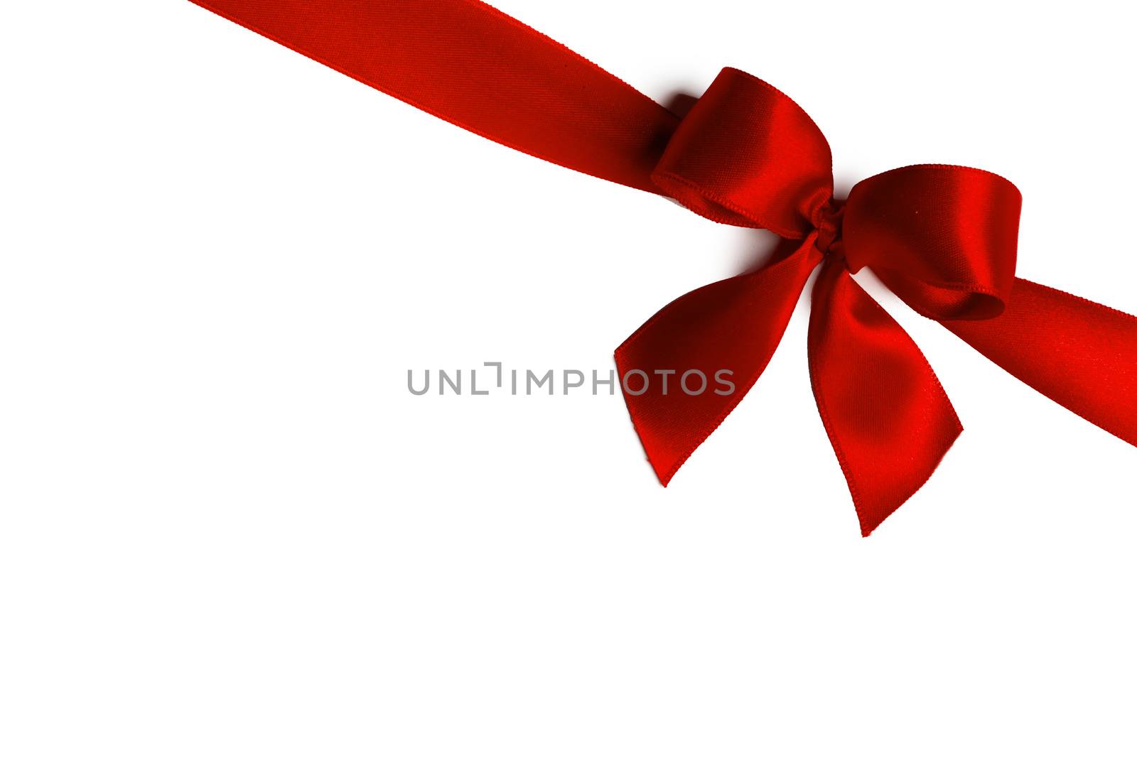 Shiny red satin ribbon and bow isolated on white background. Holiday gift concept