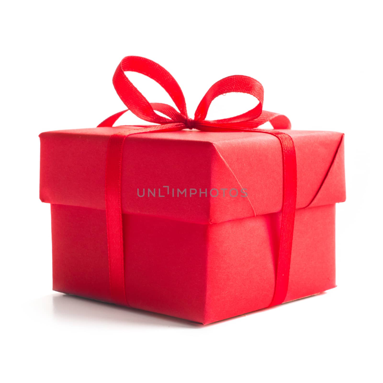 Red gift box with ribbon bow studio isolated on white background Christmas New Year birthday Valentines day anniversary concept