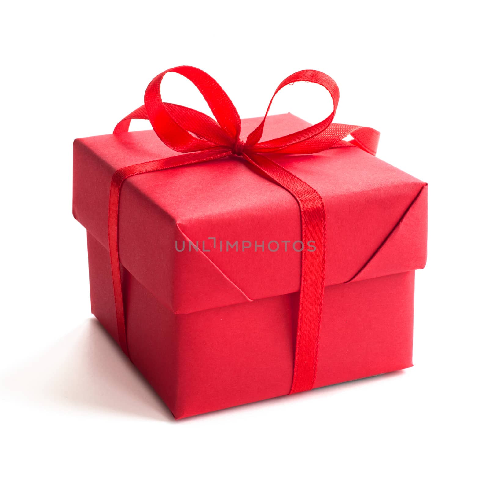 Red gift box with ribbon bow studio isolated on white background Christmas New Year birthday Valentines day anniversary concept