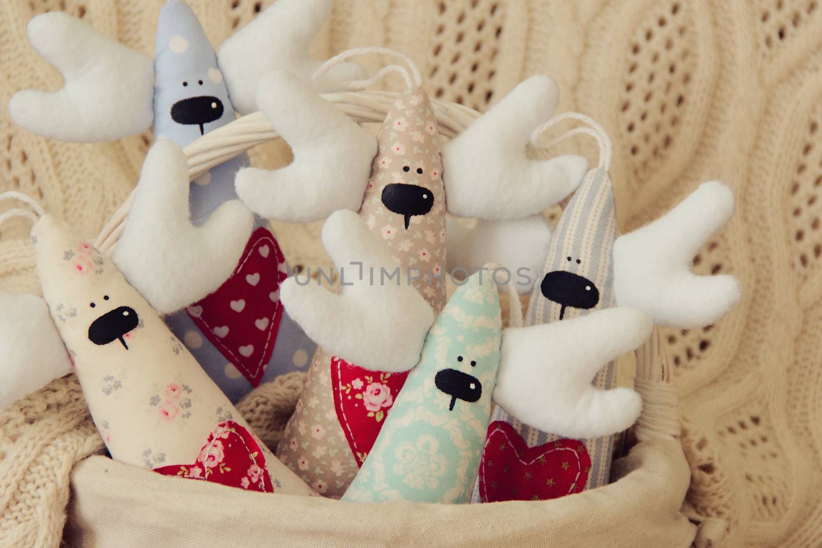 Handmade five deer for Christmas or Valentine day on basket. Background. photo