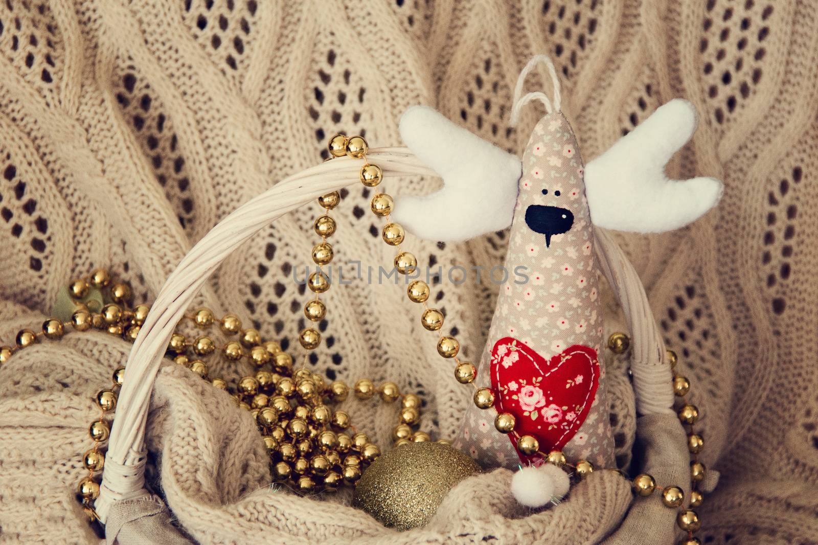 Handmade deer for Christmas or Valentine day on basket. Background. photo