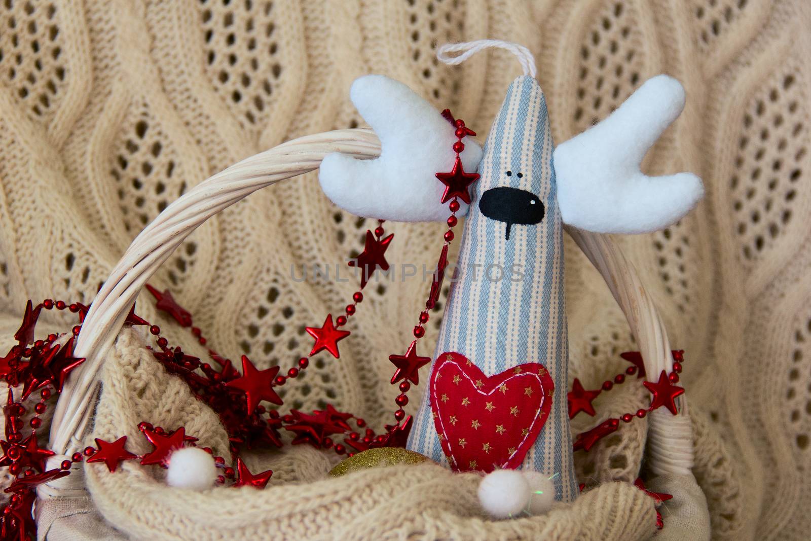 Handmade deer for Christmas or Valentine day on basket. Background. photo
