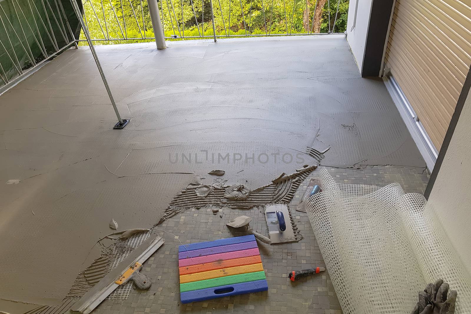 Balcony floor tiles installation. Laying tiles from porcelain. Interior remodeling theme.